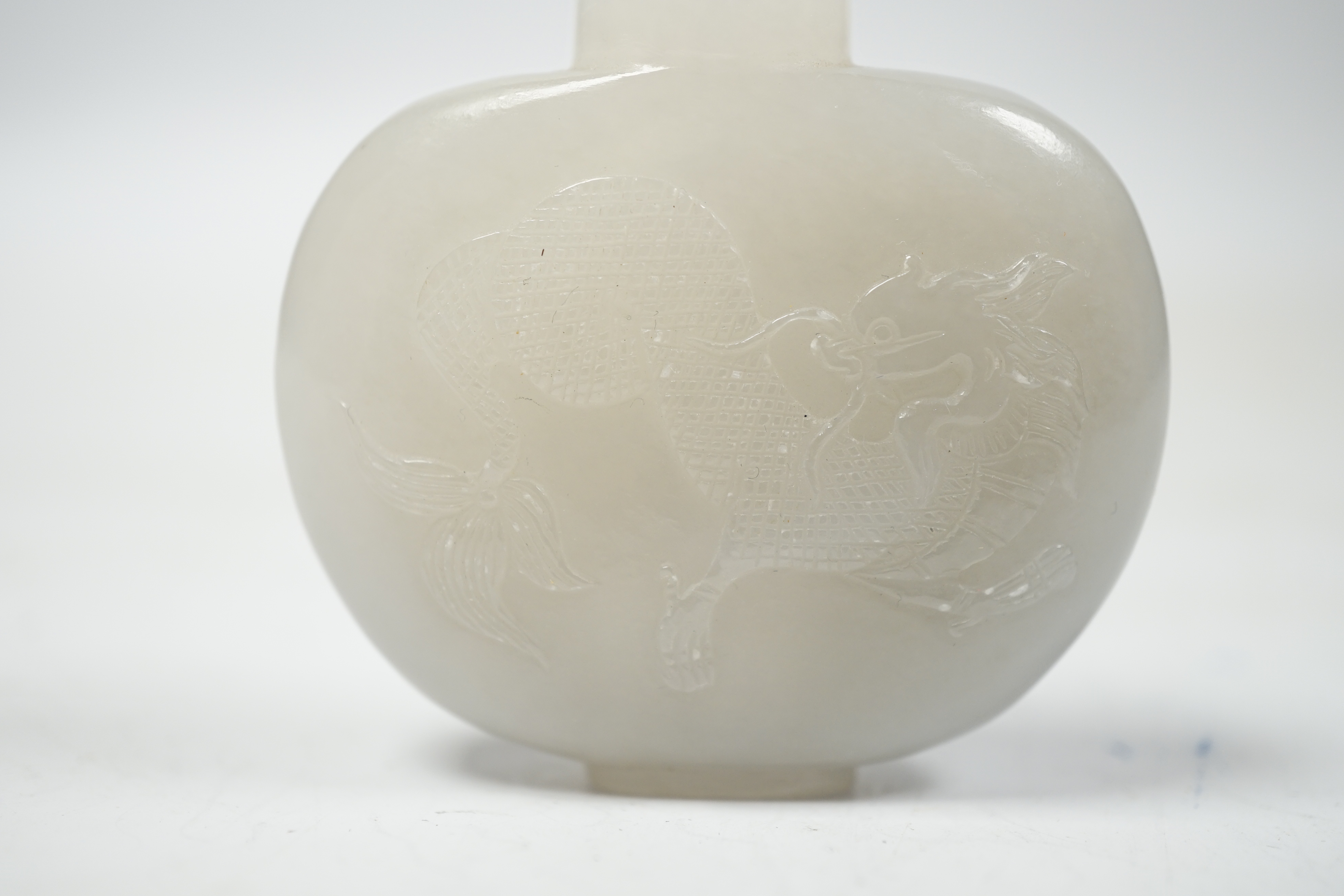 A Chinese white jade ‘chilong’ snuff bottle, 5.5cm wide